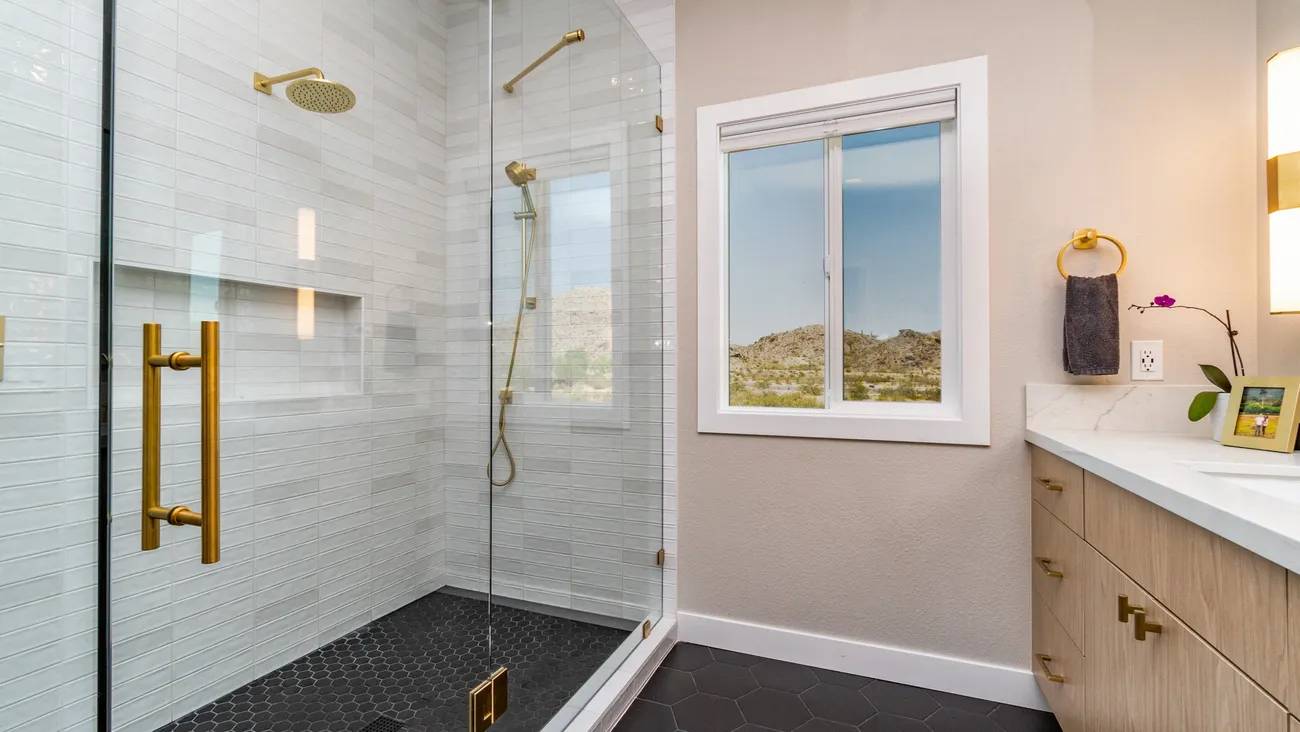 A bathroom with a shower and window in it