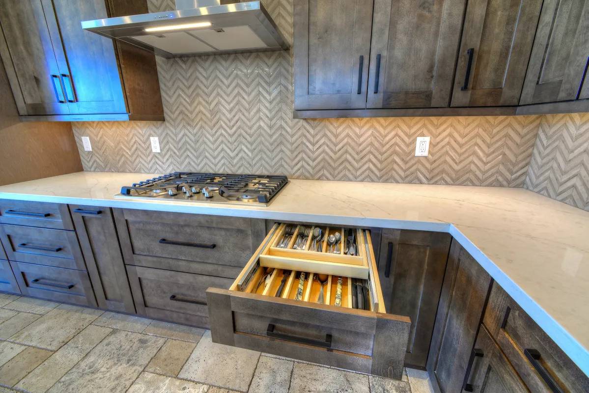 A kitchen with wooden cabinets and drawers in it