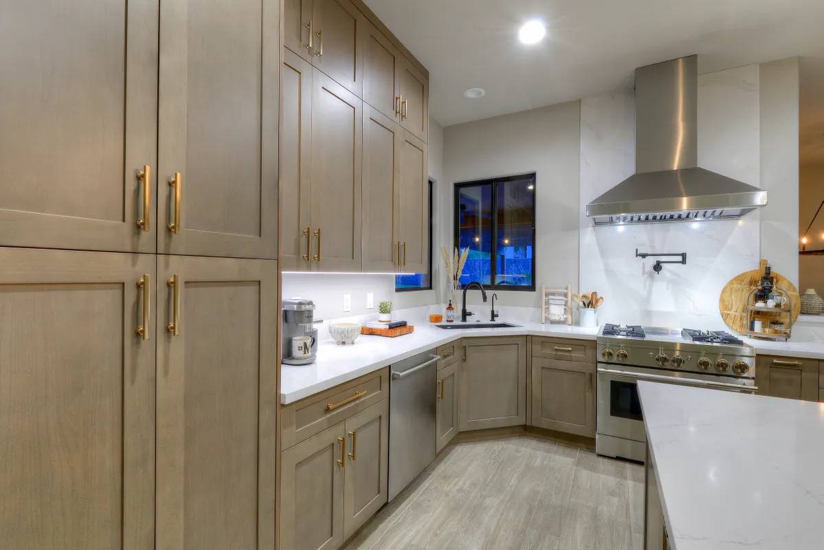 A kitchen with wooden cabinets and white counters.