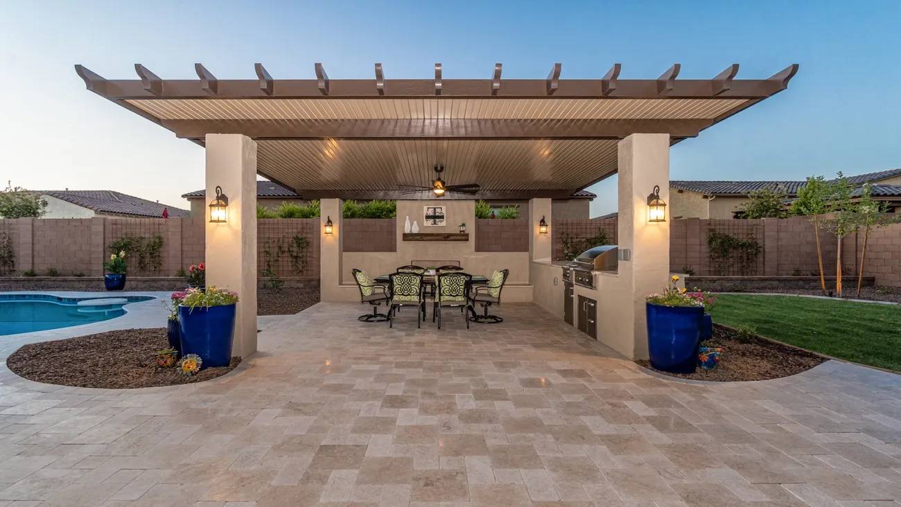 A patio with an outdoor grill and seating area.