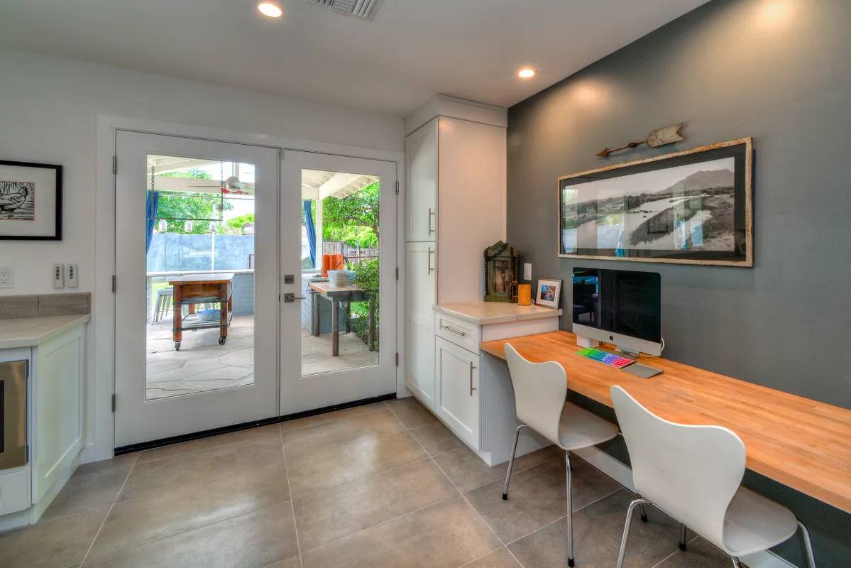 A kitchen with an open door and a table