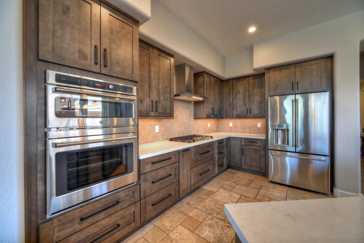 A kitchen with wooden cabinets and stainless steel appliances.