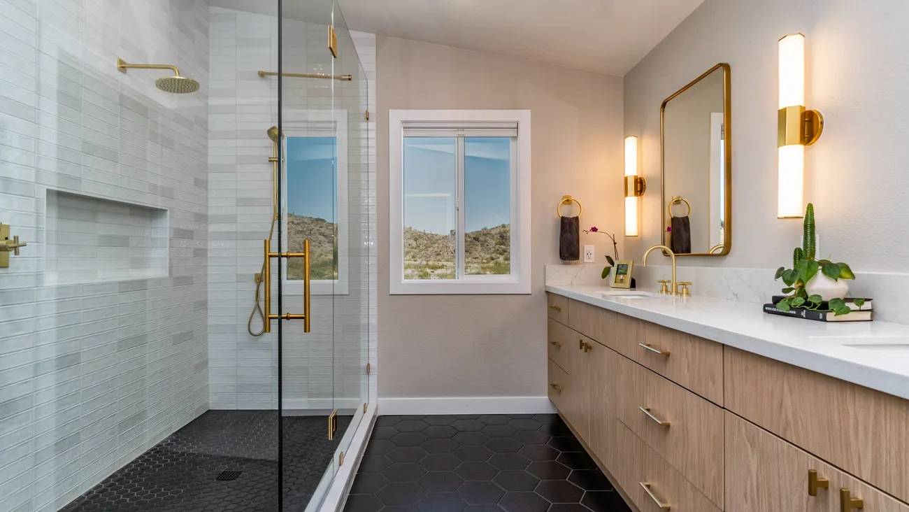 A bathroom with a large glass shower door.