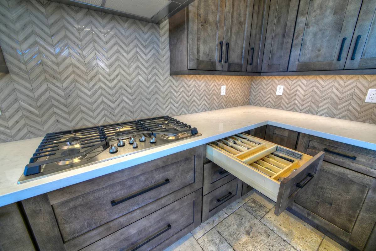 A kitchen with wooden cabinets and drawers.