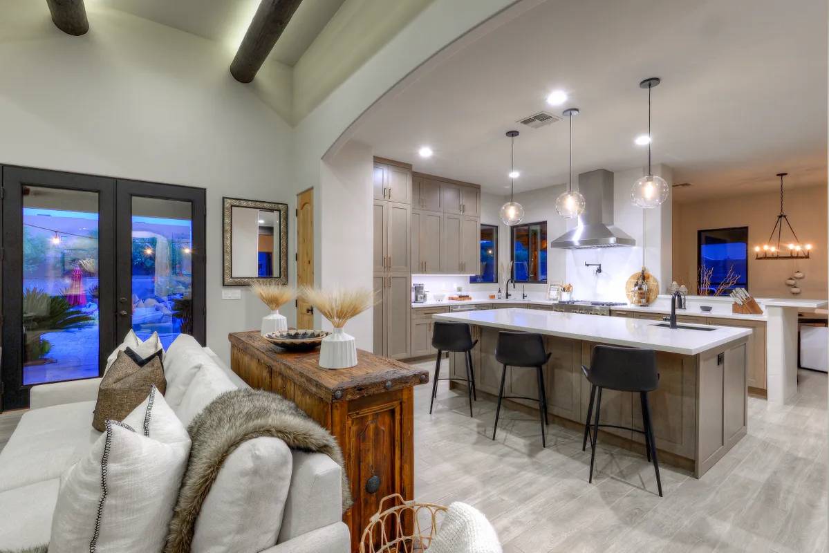 A living room with a bar and kitchen in it