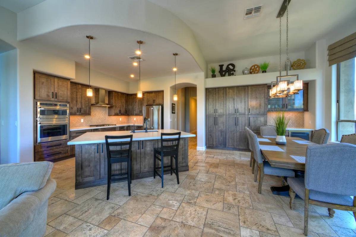 A kitchen with a table and chairs in it