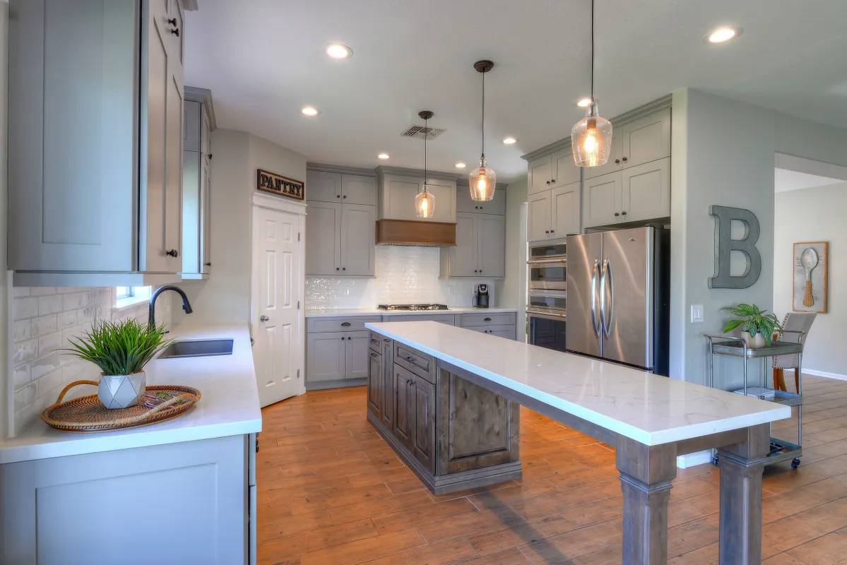 A kitchen with an island and white cabinets