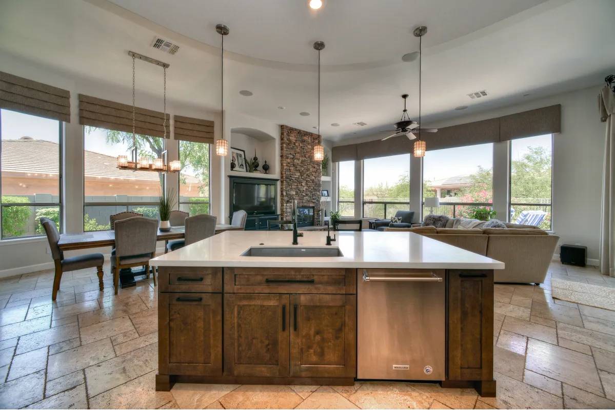 A kitchen with a large island and a sink.