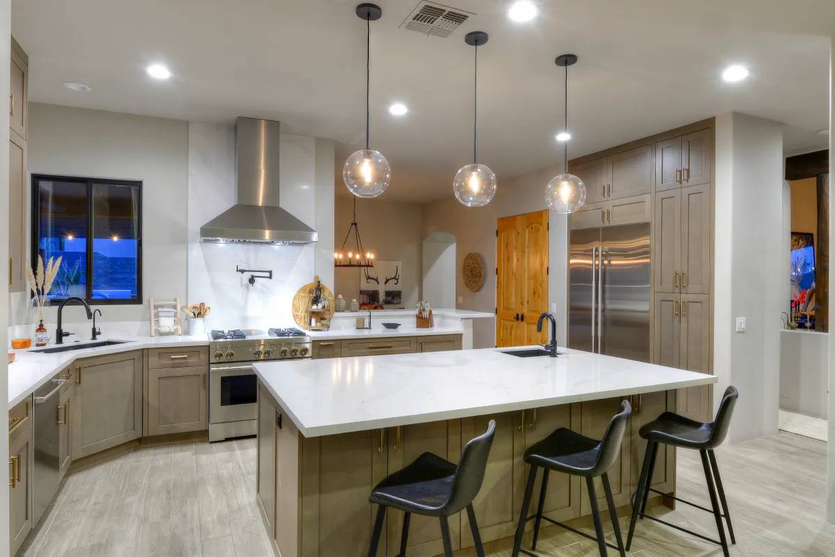 A kitchen with a large island and lots of counter space.