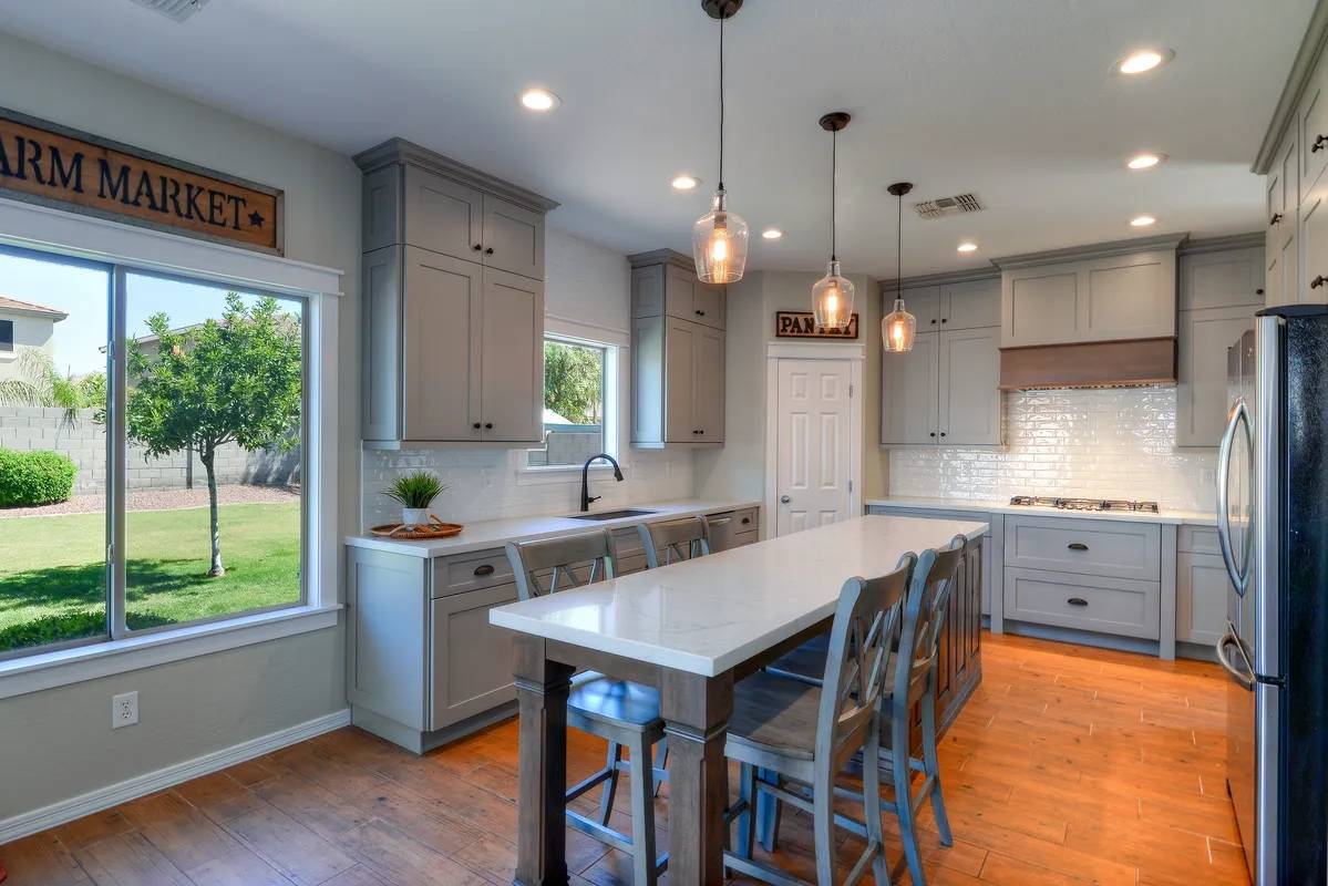 A kitchen with a table and chairs in it